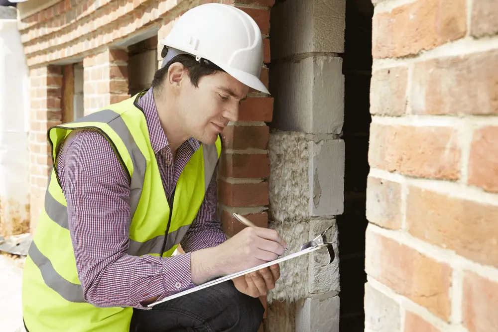 Image of a man with safety vest doing a pre-purchase house inspections